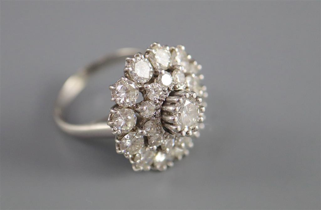 A modern 14ct white gold and diamond cluster ring,
